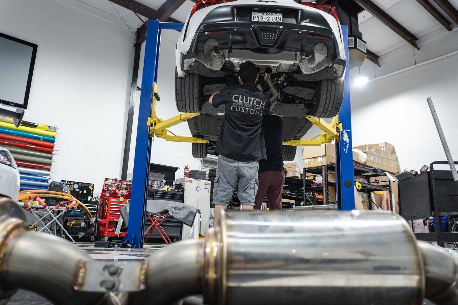 Exhaust system work on a car raised on a lift