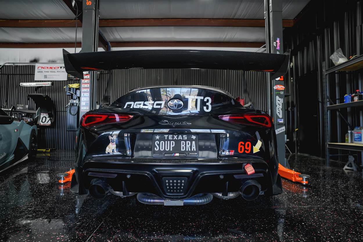 Black Toyota Supra track car in a service bay
