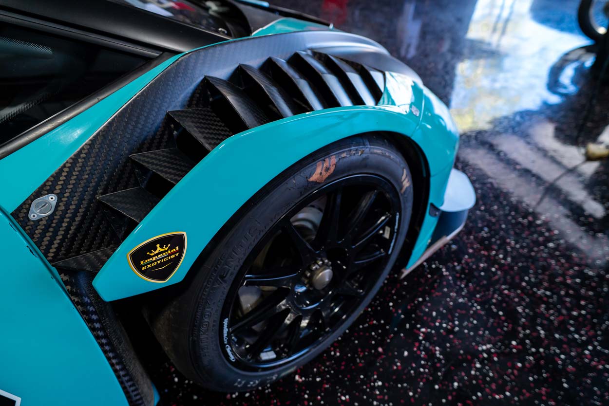 Carbon fiber fender vents on a teal supercar